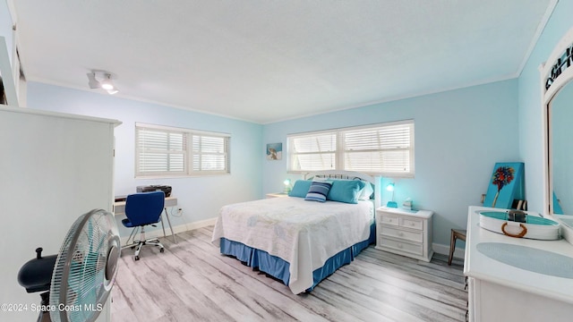 491 Indian Creek Dr, Cocoa Beach, FL 32931 - bedroom with light wood-style floors, baseboards, crown molding, and an office area