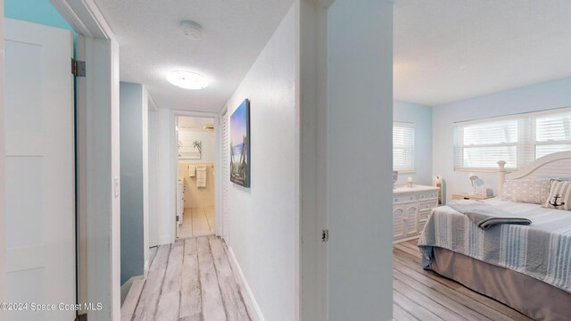 491 Indian Creek Dr, Cocoa Beach, FL 32931 - hall featuring light wood-style flooring and baseboards
