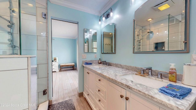 491 Indian Creek Dr, Cocoa Beach, FL 32931 - full bathroom with ornamental molding, a shower stall, double vanity, and wood finished floors