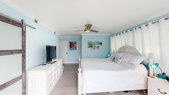 491 Indian Creek Dr, Cocoa Beach, FL 32931 - bedroom featuring crown molding, light wood finished floors, ceiling fan, a barn door, and baseboards