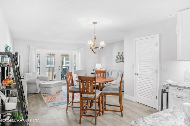 dining room featuring light hardwood / wood-style floors and an inviting chandelier