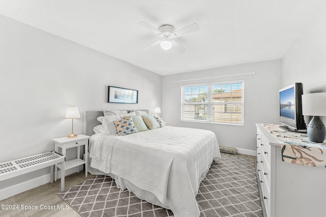 bedroom featuring ceiling fan and light hardwood / wood-style flooring