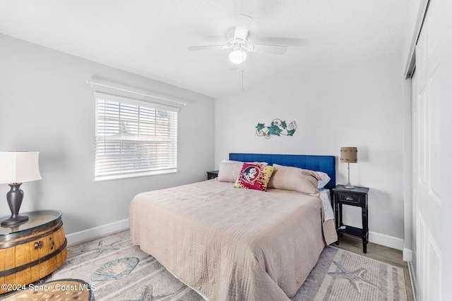 bedroom with ceiling fan and light wood-type flooring