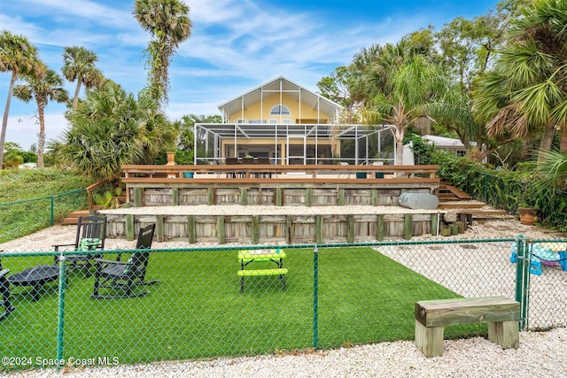 view of swimming pool featuring a lanai and a lawn