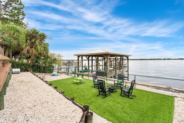 exterior space featuring a gazebo, a yard, and a water view