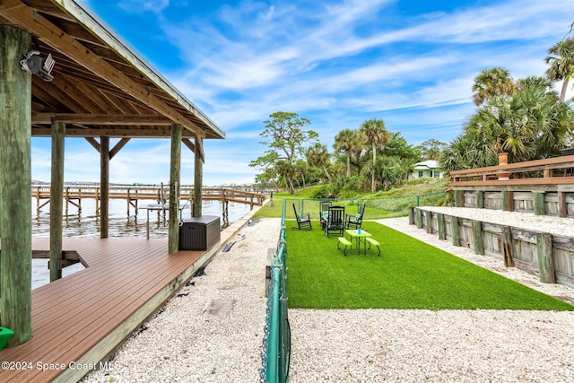 view of dock featuring a yard and a water view