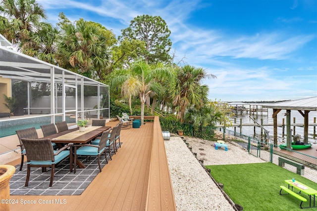 deck featuring a boat dock, a water view, and a lanai