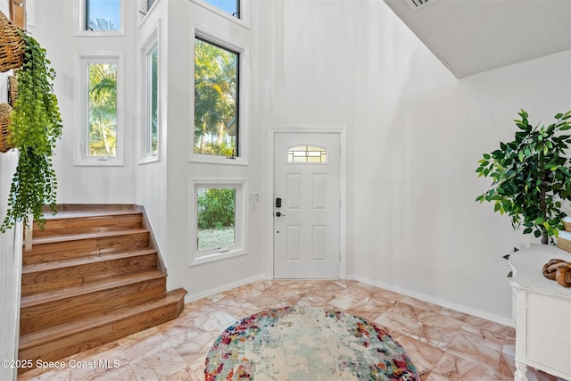 foyer featuring a towering ceiling