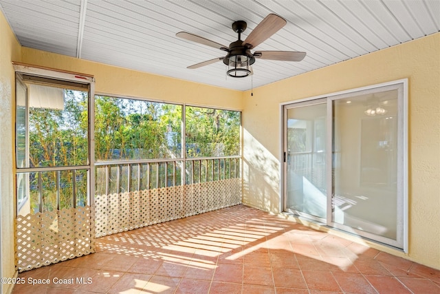 unfurnished sunroom with ceiling fan and plenty of natural light