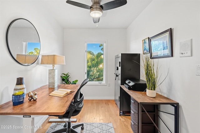 home office with ceiling fan and light hardwood / wood-style floors