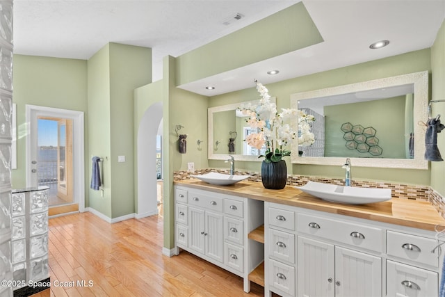 bathroom with hardwood / wood-style flooring and vanity