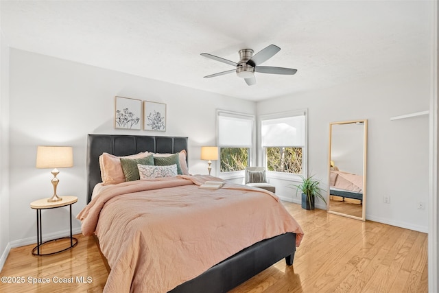 bedroom with ceiling fan and light wood-type flooring