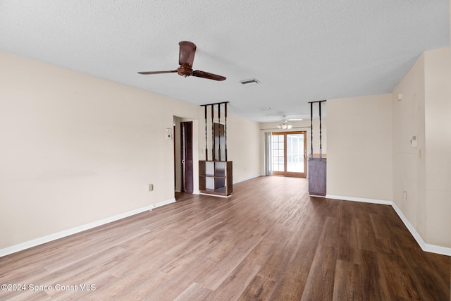 unfurnished living room with a textured ceiling, hardwood / wood-style flooring, and ceiling fan