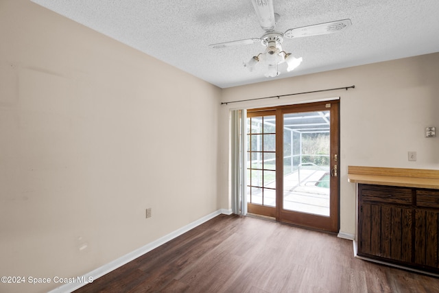 interior space featuring a textured ceiling, hardwood / wood-style flooring, and ceiling fan