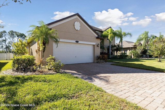 view of front of house featuring a front yard and a garage