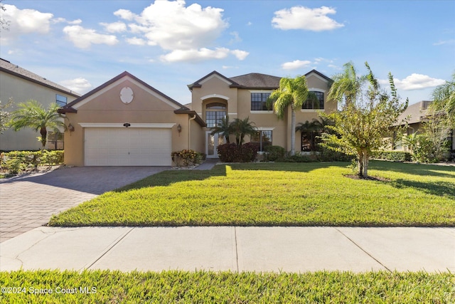 view of front of home featuring a front lawn and a garage