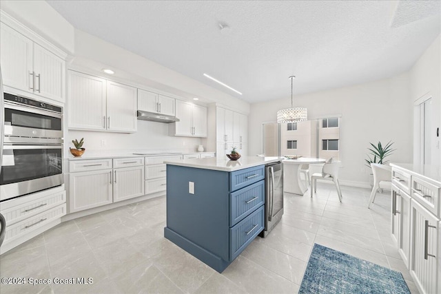 kitchen featuring a center island, white cabinets, double oven, decorative light fixtures, and electric stovetop