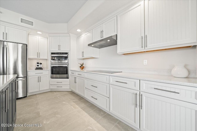 kitchen with white cabinets, light tile patterned flooring, and appliances with stainless steel finishes