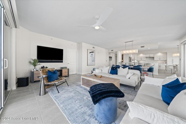 tiled living room with ceiling fan