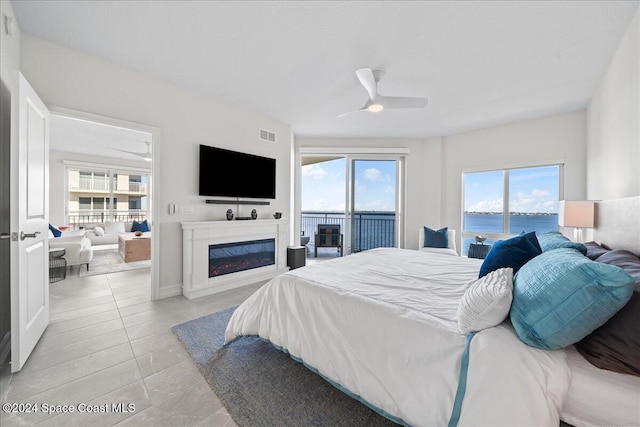 bedroom featuring light tile patterned floors, access to outside, multiple windows, and ceiling fan