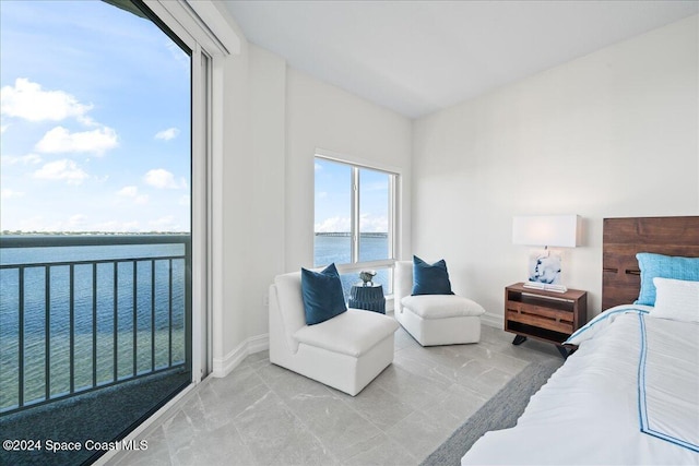 carpeted bedroom with a water view