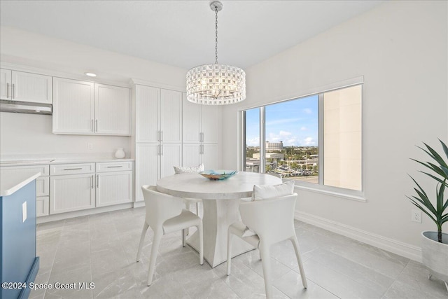 tiled dining space with a chandelier