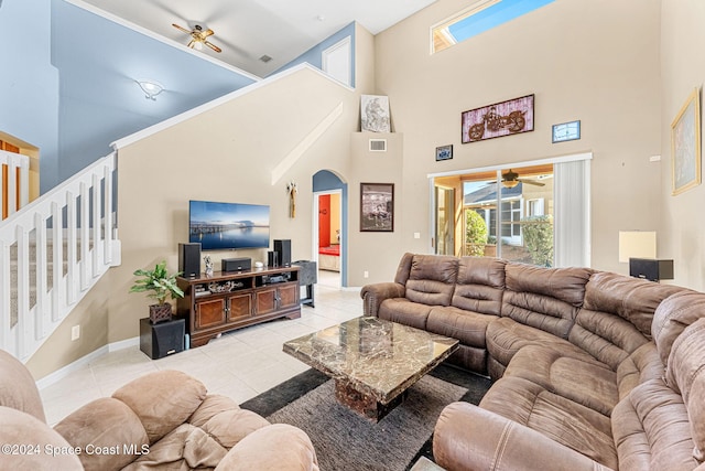 tiled living room featuring a towering ceiling