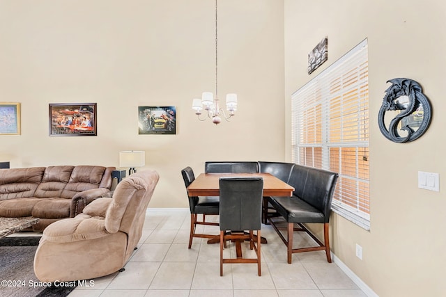 dining area with a chandelier and light tile patterned flooring