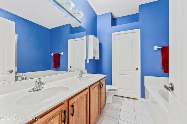 bathroom featuring a textured ceiling, tile patterned floors, vanity, toilet, and a bath