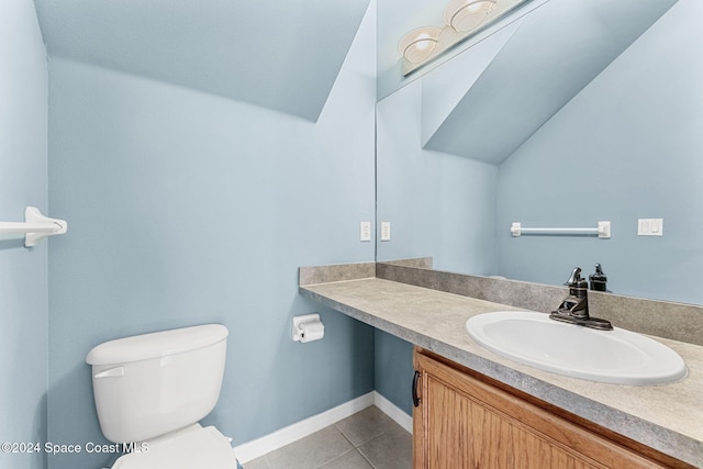 bathroom featuring toilet, vanity, and tile patterned flooring