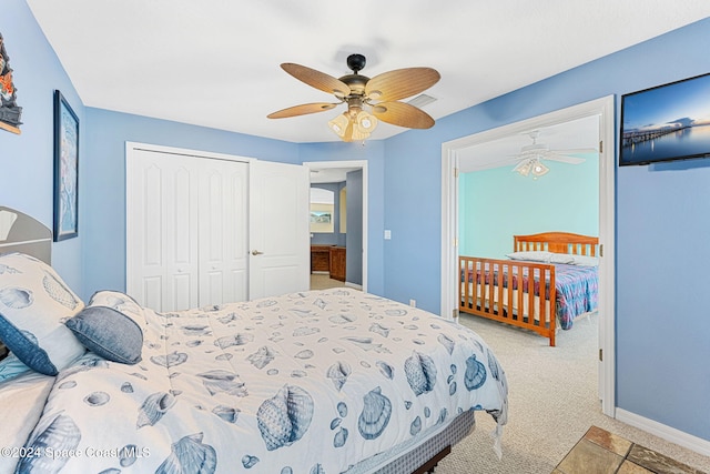 carpeted bedroom with ceiling fan and a closet