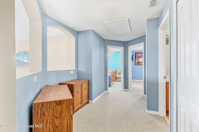 corridor featuring a textured ceiling