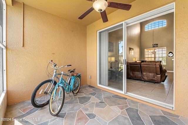 exterior space with ceiling fan