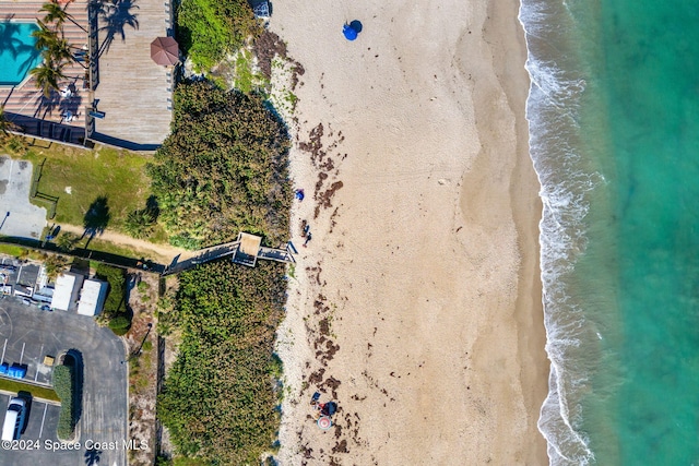 aerial view with a water view and a beach view