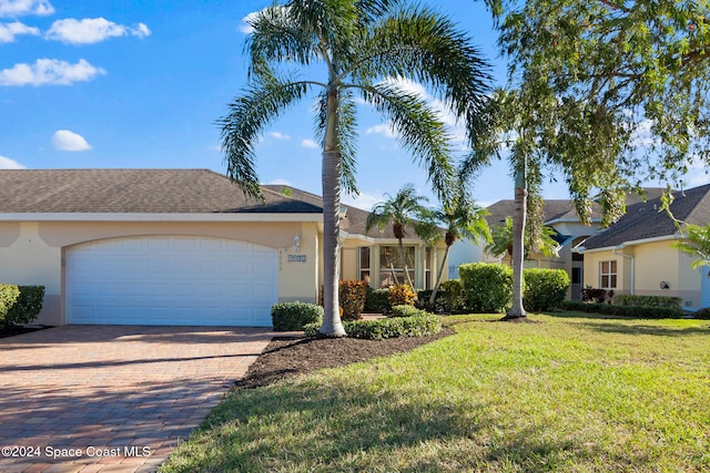 ranch-style house with a front yard and a garage