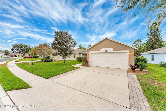 ranch-style home featuring a garage and a front lawn