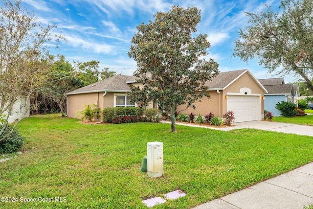 ranch-style house featuring a front yard and a garage