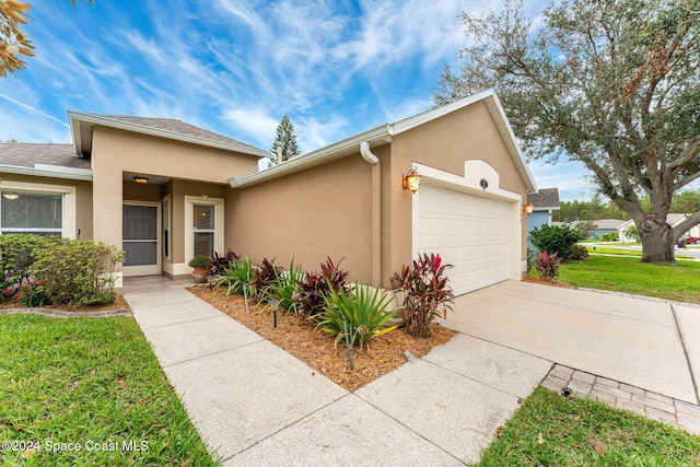 2122 Spring Creek Cir NE, Palm Bay, FL 32905 - view of front of house with stucco siding, a garage, a front lawn, and concrete driveway