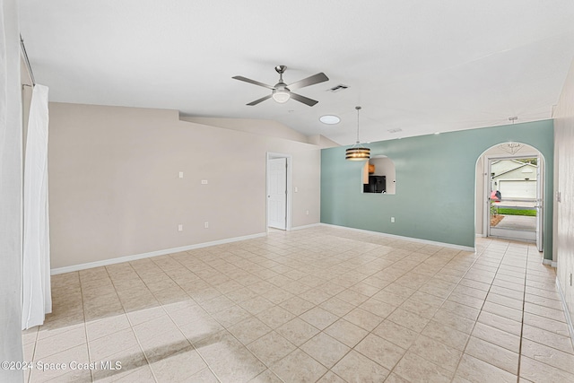 tiled spare room with vaulted ceiling and ceiling fan