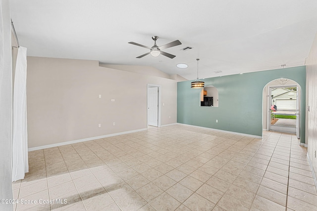 2122 Spring Creek Cir NE, Palm Bay, FL 32905 - empty room with a ceiling fan, arched walkways, light tile patterned floors, lofted ceiling, and baseboards