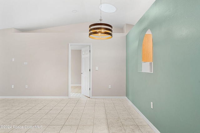 unfurnished room with a chandelier and vaulted ceiling