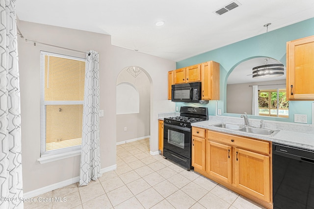 kitchen with light tile patterned floors, sink, and black appliances