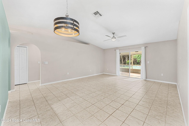2122 Spring Creek Cir NE, Palm Bay, FL 32905 - spare room featuring a ceiling fan, arched walkways, light tile patterned floors, lofted ceiling, and baseboards
