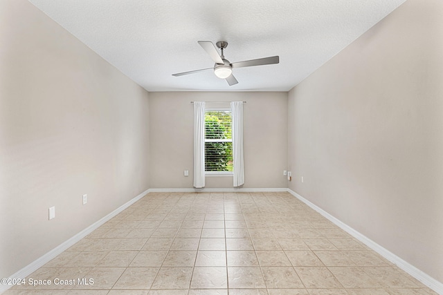 2122 Spring Creek Cir NE, Palm Bay, FL 32905 - spare room with ceiling fan, baseboards, a textured ceiling, and light tile patterned flooring
