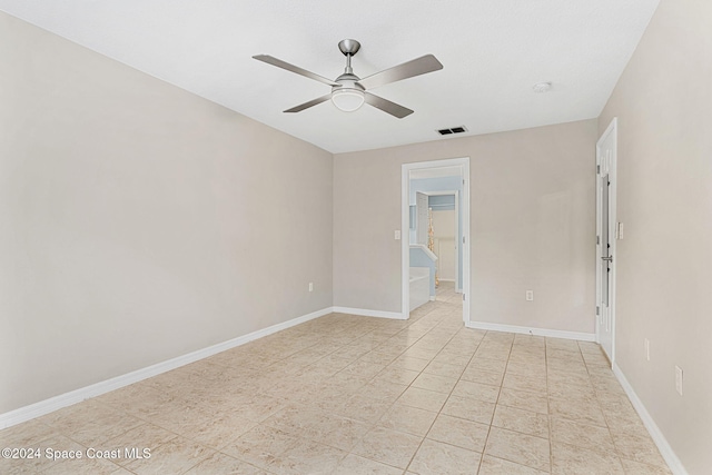 spare room featuring ceiling fan and light tile patterned flooring