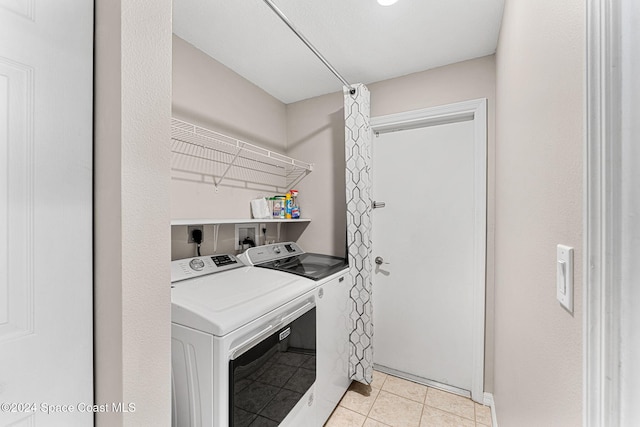 2122 Spring Creek Cir NE, Palm Bay, FL 32905 - washroom with washer and clothes dryer and light tile patterned flooring