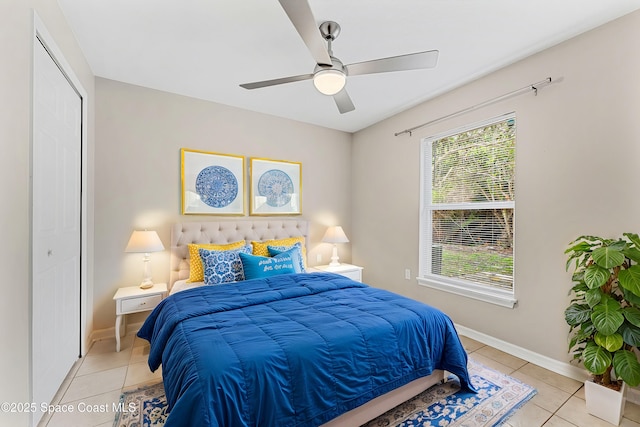 tiled bedroom with a closet and ceiling fan