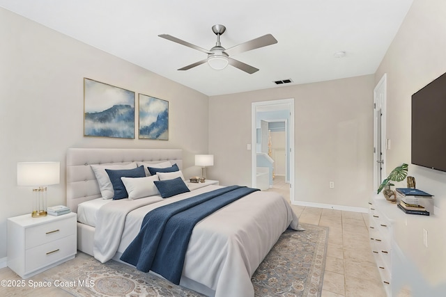 bedroom featuring light tile patterned floors, ceiling fan, and ensuite bathroom