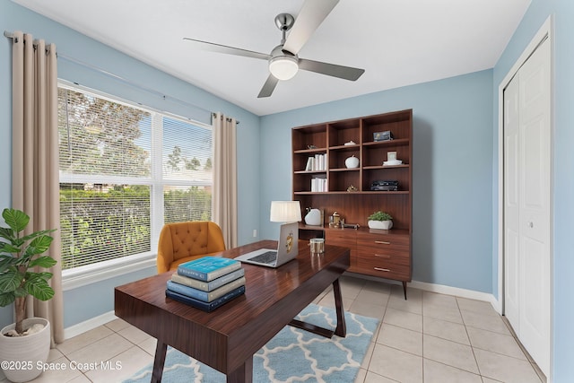 tiled office space with ceiling fan and a healthy amount of sunlight