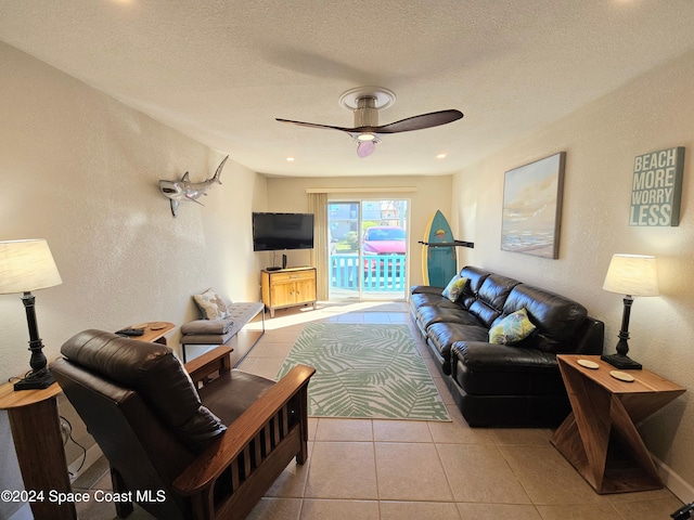 tiled living room featuring a textured ceiling and ceiling fan